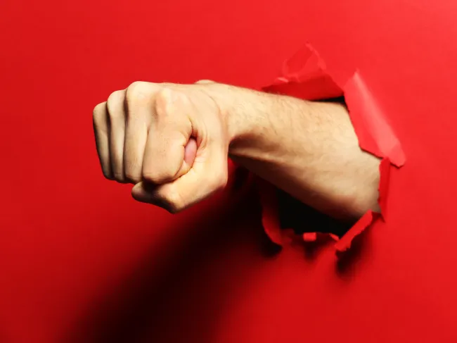 fist punch through red paper